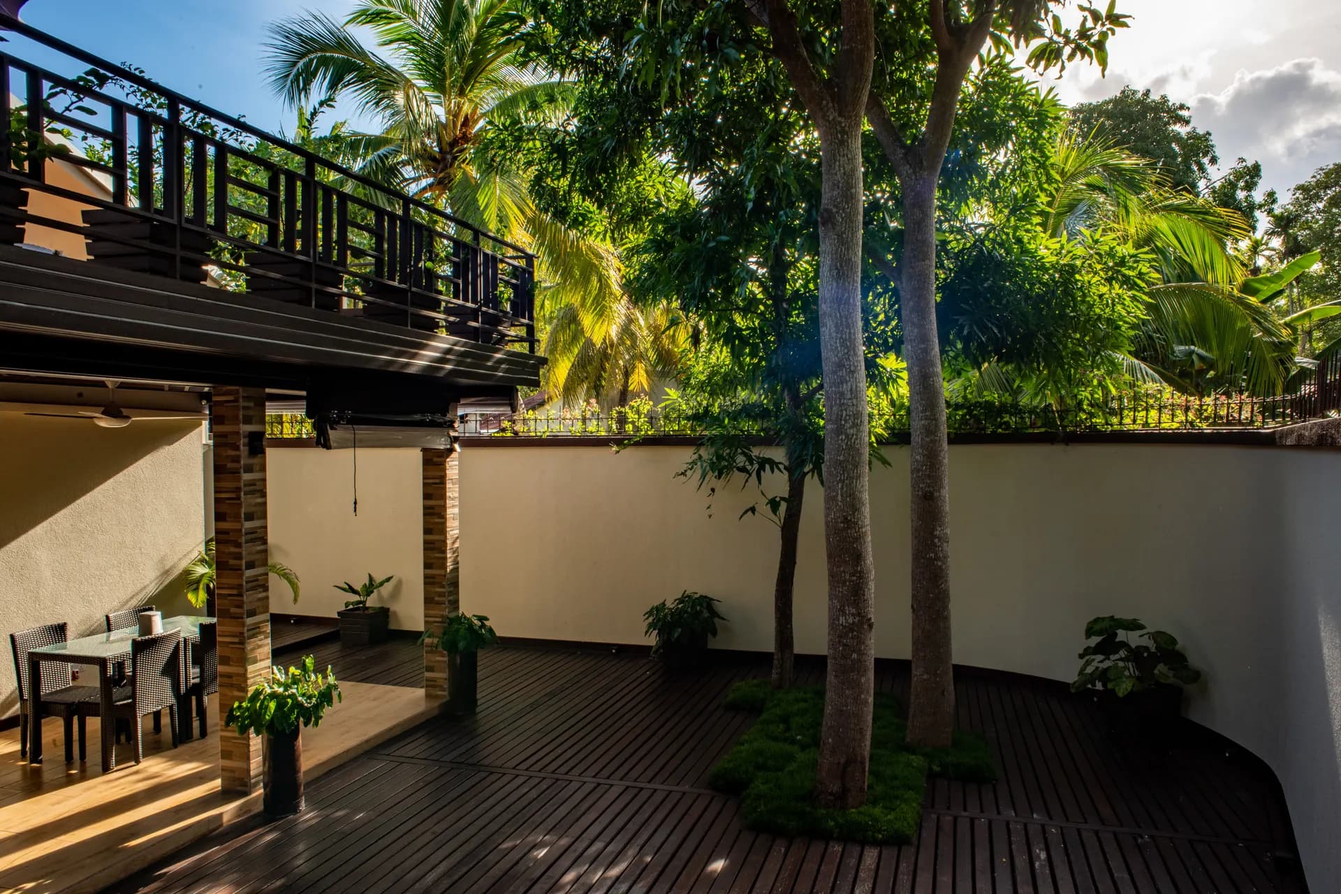 The courtyard deck and dining tables under the trees