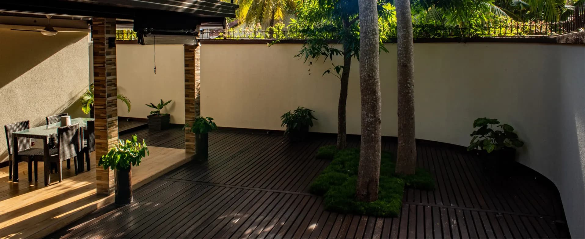 The inn's timber courtyard with palm trees
